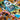 Family game Prehistories by The Flying Games featuring colorful dinosaur-themed cards and game pieces on a wooden surface.