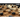 Abstract strategy game Shōbu by Smirk & Laughter Games, showing a wooden game board with black and white stones in play.