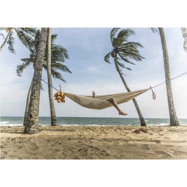 Kylskapspoesi adult puzzle featuring a beach hammock scene with colorful hammock strung between palm trees on a sunny beach.