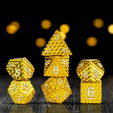 FanRoll D&D Dragon Scale metal dice set in gold with detailed dragon scale pattern, includes multiple polyhedral dice.