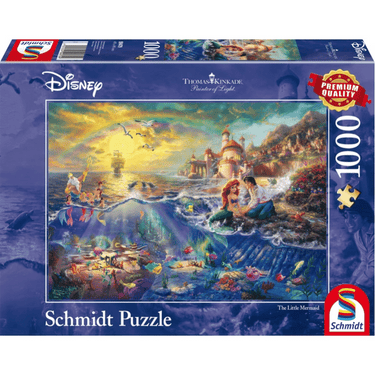 Adult puzzle featuring Disney's Thomas Kinkade The Little Mermaid by Schmidt, showing colorful underwater scene with Ariel and sea creatures.