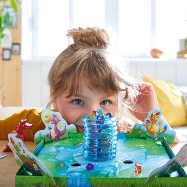 HABA Dragon's Breath children's game with colorful dragon-themed game pieces and playing cards on a game board.