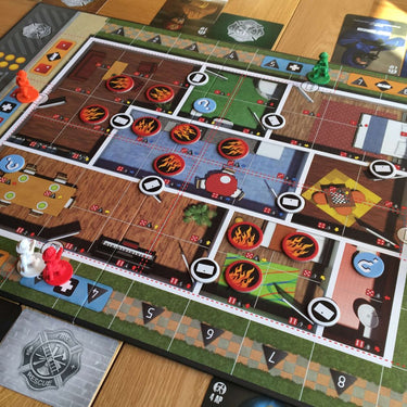 Family game box for Flash Point: Fire Rescue by Indie Boards & Cards, showing colorful game components and firefighter artwork.