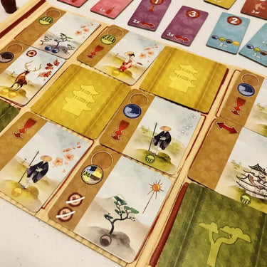 Family board game Kanagawa by IELLO featuring colorful artwork and game components on a wooden table.