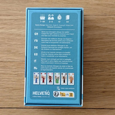 Family game Odin by Helvetiq featuring colorful, illustrated cards and game pieces on a wooden table.