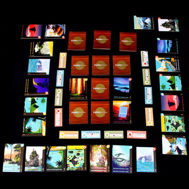Family playing Parks Memories: Coast to Coast, a Keymaster Games family game with colorful game components and a scenic board.