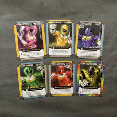 Power Rangers Zeo deck-building game by Renegade Game Studios, featuring colorful cards and character artwork for family fun.