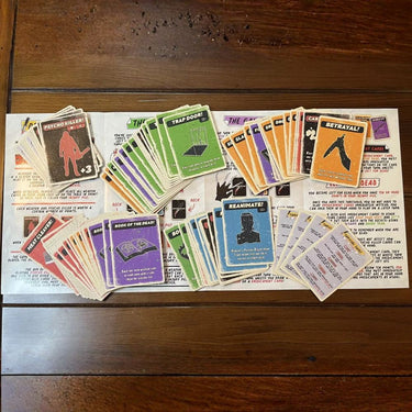 Escape Tabletop Games Psycho Killer party game box with colorful artwork and game components on a table.