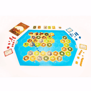 Catan: Treasures, Dragons & Adventurers family game box with colorful artwork featuring dragons, treasure chests, and adventurers.