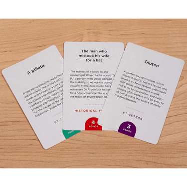 CMYK Monikers Classics Expansion party game box with colorful card artwork and game components for social play.
